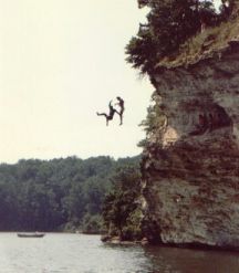 two guys are cliff jumping
